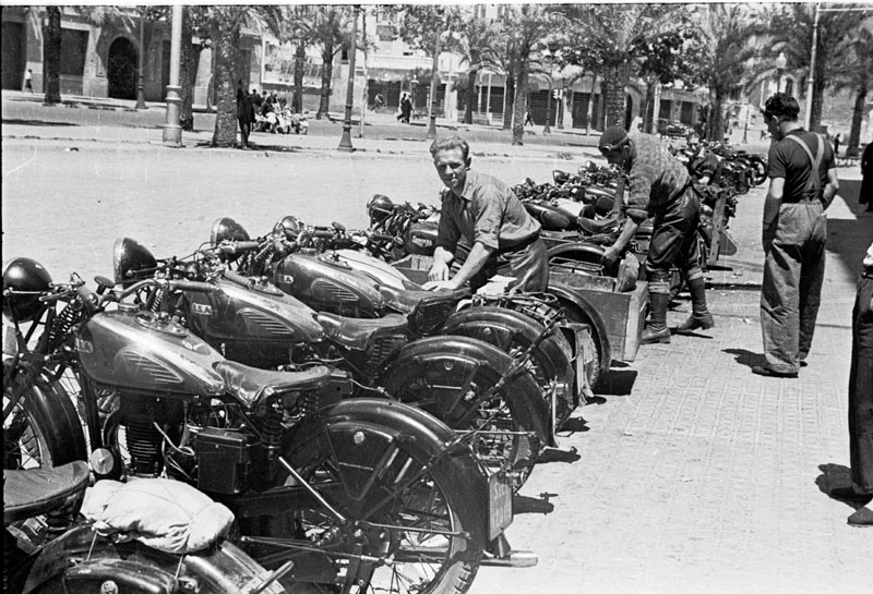 Motos_dispuestas_en_hilera_Unos_mec_nicos_las_reparan